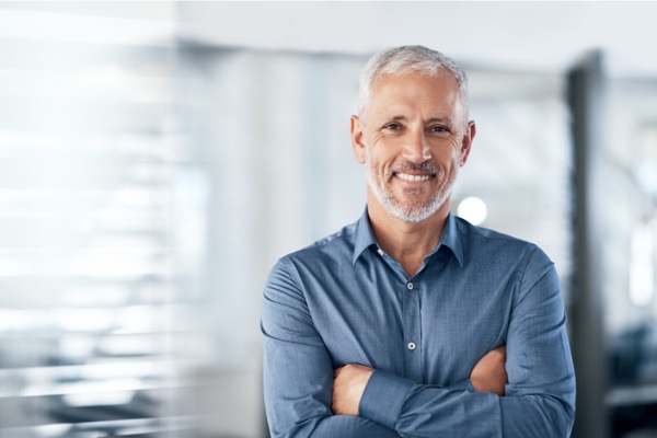 Mature man sitting down looking at camera